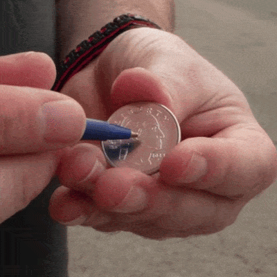 Pen Through Coin by Michael Ammar